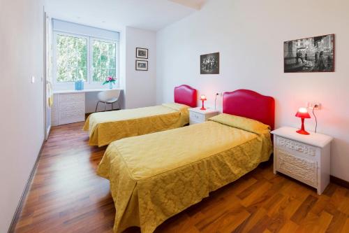 a room with two beds and a window at Villa Boer in Bibione