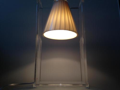 a light that is reflected in a mirror at Hotel Yllen Eiffel in Paris