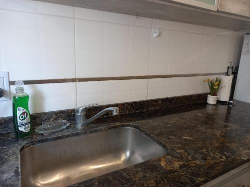 a kitchen counter with a sink in a kitchen at Al mar! in Mar del Plata