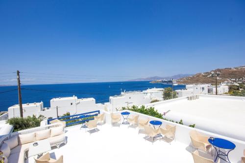 a balcony with chairs and a view of the ocean at Hotel Spanelis in Mýkonos City