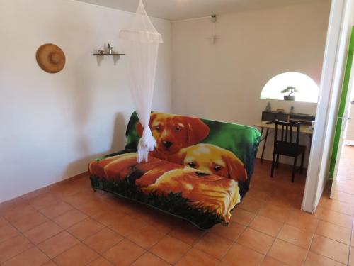 a brown dog sitting on a couch in a living room at TERRE DE BAS :L'île merveilleuse in Terre-de-Bas