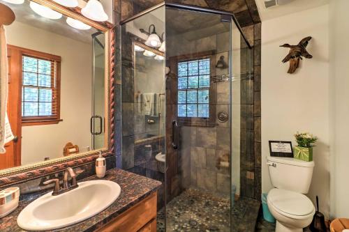 a bathroom with a shower and a toilet and a sink at Waterfront West Point Lake Cabin with Private Dock! in Whitewater Woods