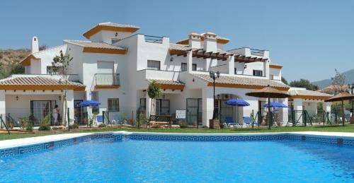 a large house with a swimming pool in front of it at Castillo de Zalia Conjunto Rural in Alcaucín