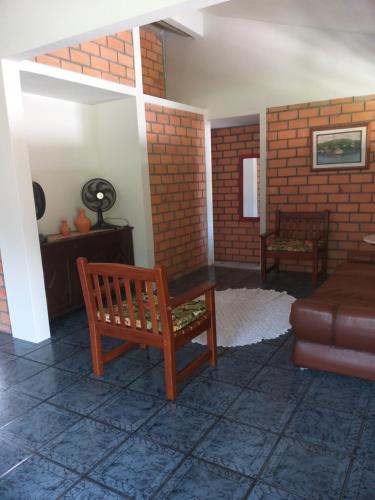 a living room with a bench and a couch at Canto Leste Pousada in Florianópolis