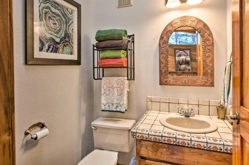 a small bathroom with a sink and a toilet at Cozy Angel Fire Escape with Golf Course Views! in Angel Fire