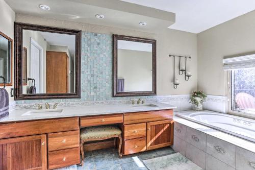 ein Badezimmer mit zwei Waschbecken, einer Badewanne und einer Badewanne in der Unterkunft Bright Centennial Home about 15 Mi to Dtwn Denver in Centennial
