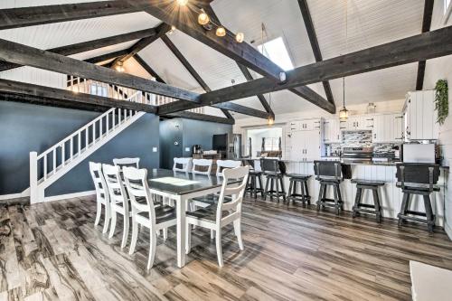 a dining room with a table and chairs at Spacious Massillon Log Cabin with Fire Pit! in Massillon