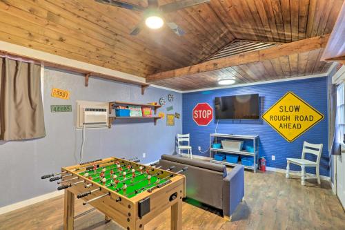 a room with a foosball table and a stop sign at 1920s Corsicana Home - Spacious Group Getaway! in Corsicana