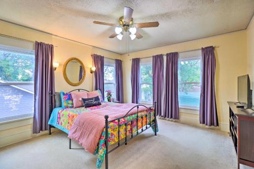 a bedroom with a bed and a ceiling fan at 1920s Corsicana Home - Spacious Group Getaway! in Corsicana