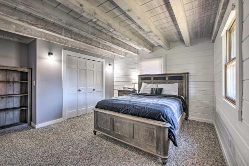 a bedroom with a bed with a wooden head board at Spacious Massillon Log Cabin with Fire Pit! in Massillon