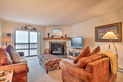a living room with couches and a television and a fireplace at Ski, Hike and Explore All-Season Frisco Condo in Frisco