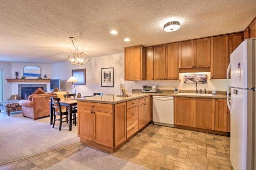 a kitchen with wooden cabinets and a dining room at Ski, Hike and Explore All-Season Frisco Condo in Frisco