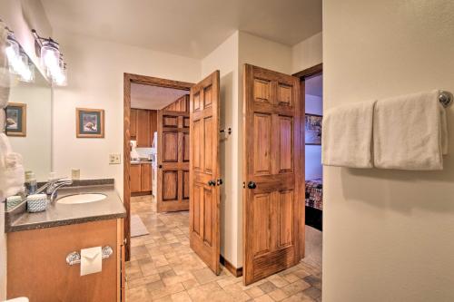 a bathroom with a sink and a door to a room at Ski, Hike and Explore All-Season Frisco Condo in Frisco