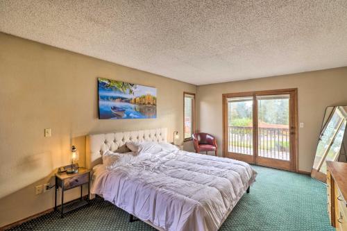 a bedroom with a large white bed and a window at Serene Lakeside Hideaway with Deck in Downtown! in Lakeside