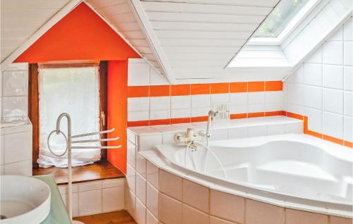 a bathroom with a large tub and a skylight at 3 Bedroom Stunning Home In Pont Aven in Pont-Aven
