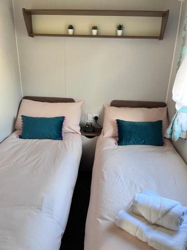 two beds sitting next to each other in a room at Lovely 3 bedroom holiday home in Seton Sand caravan park Wi-Fi Xbox in Edinburgh