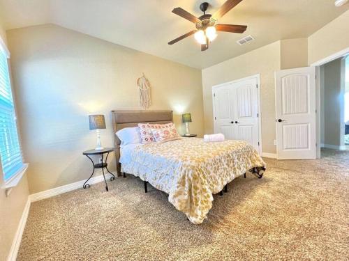 a bedroom with a bed and a ceiling fan at Furnished, Modern & Spacious Home - AFB Guests Special - Media Room, Self Checkin, Garage in San Antonio
