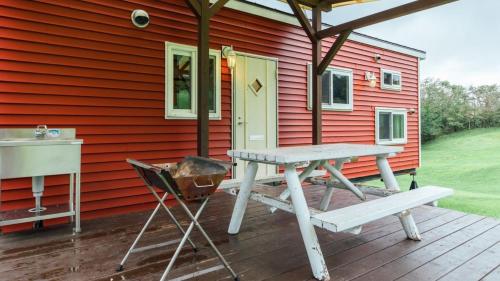 a house with a picnic table and a grill on a deck at PICA Fuji Grinpa in Susono