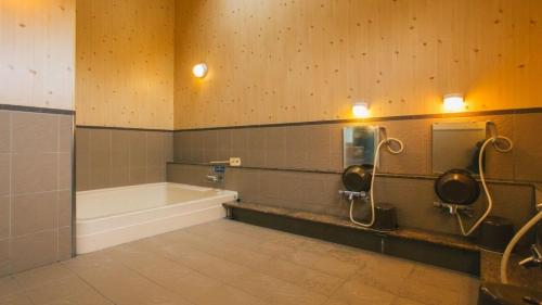 a bathroom with a bath tub and a sink at PICA Fuji Grinpa in Susono