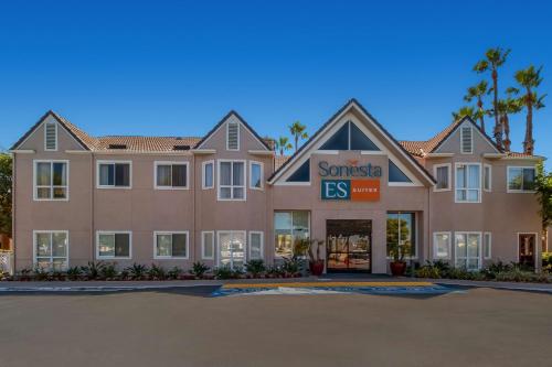 a building with a santa eis sign in front of it at Sonesta ES Suites Huntington Beach Fountain Valley in Huntington Beach