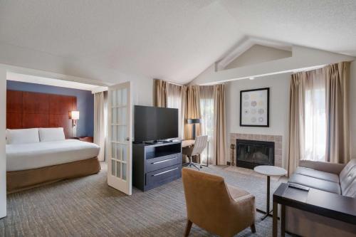 a hotel room with a bed and a living room at Sonesta ES Suites Huntington Beach Fountain Valley in Huntington Beach