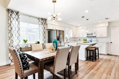 a kitchen and dining room with a wooden table and chairs at Super Cozy Entire House ABL Near Downtown - Book Now !! in Katy