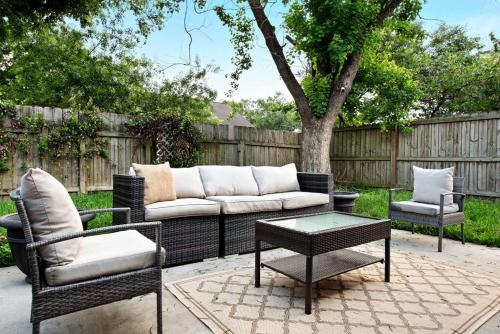 a patio with a couch and two chairs and a table at Super Cozy Entire House ABL Near Downtown - Book Now !! in Katy