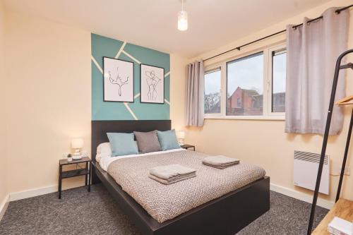 a bedroom with a bed and two windows at Large 2 Bed in Central Coventry - Sleeps 6 - Parking in Coventry