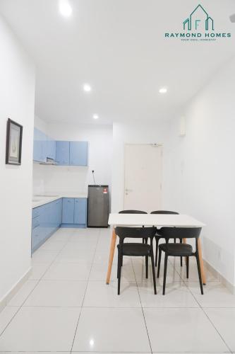 a kitchen with two tables and chairs in a room at Gurney Drive Mansion One Serviced Apartment in George Town