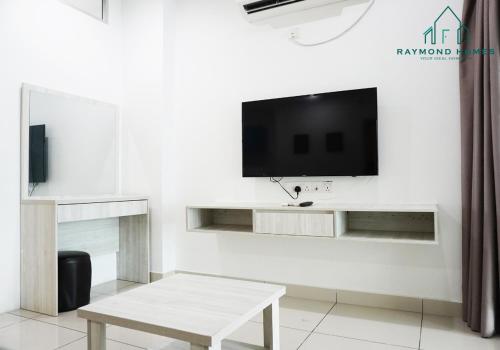 a living room with a tv on a white wall at Gurney Drive Mansion One Serviced Apartment in George Town