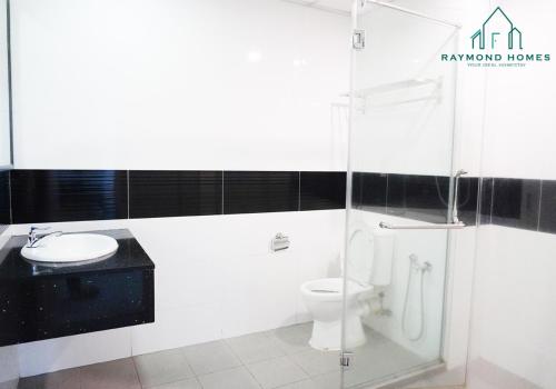 a bathroom with a toilet and a sink at Gurney Drive Mansion One Serviced Apartment in George Town