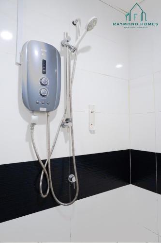a shower in a bathroom with a soap dispenser at Gurney Drive Mansion One Serviced Apartment in George Town