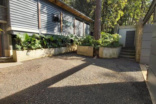 a house with two pots of plants on the side of it at Casa William en el bosque in Valle de Bravo