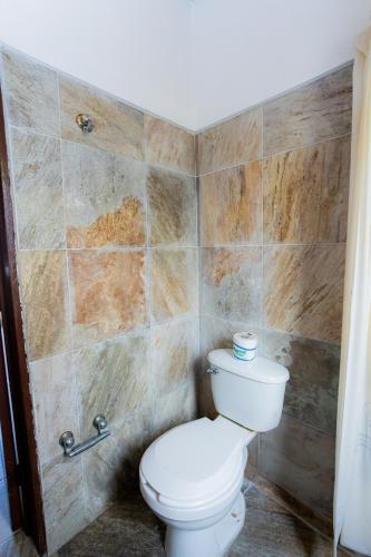a bathroom with a toilet and a shower at Bungalows Maria Teresa in Rincon de Guayabitos