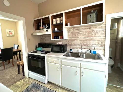 a kitchen with a sink and a stove at Cozy cottage in the heart of the big city- dog friendly in Billings