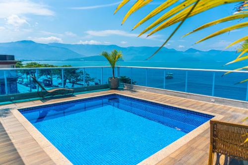 a swimming pool on the roof of a building at Ubatuba Praia Hotel in Ubatuba