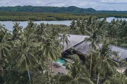 an aerial view of a resort with palm trees at Maison Bukana - King Suite in General Luna