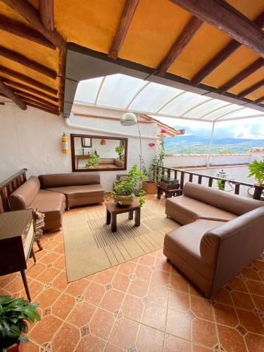 a living room with couches and a view of the ocean at AQUI ESTOY BIEN in Barichara