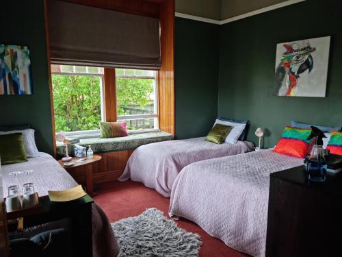 a bedroom with two beds and a window at Homestay On Queen in Westport