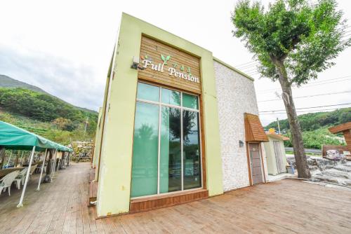 a building with a sign on the side of it at Full Pension in Gimhae