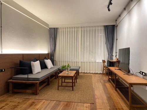 a living room with a couch and a table at GalileOasis Boutique Hotel in Bangkok