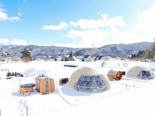 a group of tents sitting in the snow at From P in Hakuba