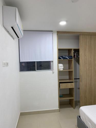 a small room with a window and a bed at Apartment near to Bello Horizonte Beach, Santa Marta Airport in Santa Marta