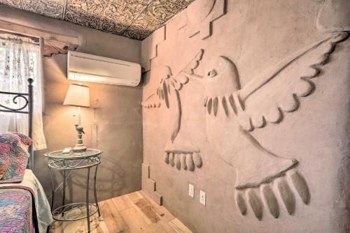 a bedroom with a wall with two birds painted on it at Artsy Santa Cruz Apartment with Shared Fire Pit! in Santa Cruz