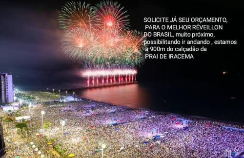 a crowd of people watching a fireworks show at Sol de Iracema centro in Fortaleza