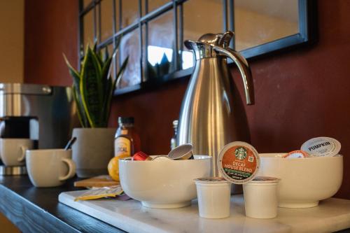 a counter with bowls and cups on a counter with a mixer at Epic View A Luxury House on a Hill River 10 min in Kernville