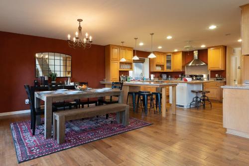 a large kitchen with a table and chairs in it at Epic View A Luxury House on a Hill River 10 min in Kernville