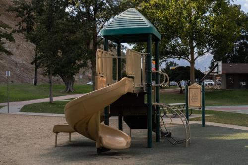 a playground with a slide in a park at Epic View A Luxury House on a Hill River 10 min in Kernville