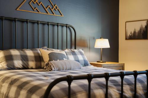 ein Bett mit einer blauen und weißen Decke und einer Lampe in der Unterkunft Epic View; A Luxury House on a Hill in Kernville