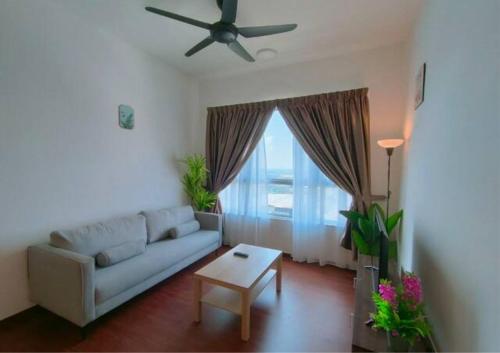 a living room with a couch and a ceiling fan at Cozy 2R2B Relaxing Skyline Views #GA2 in Shah Alam